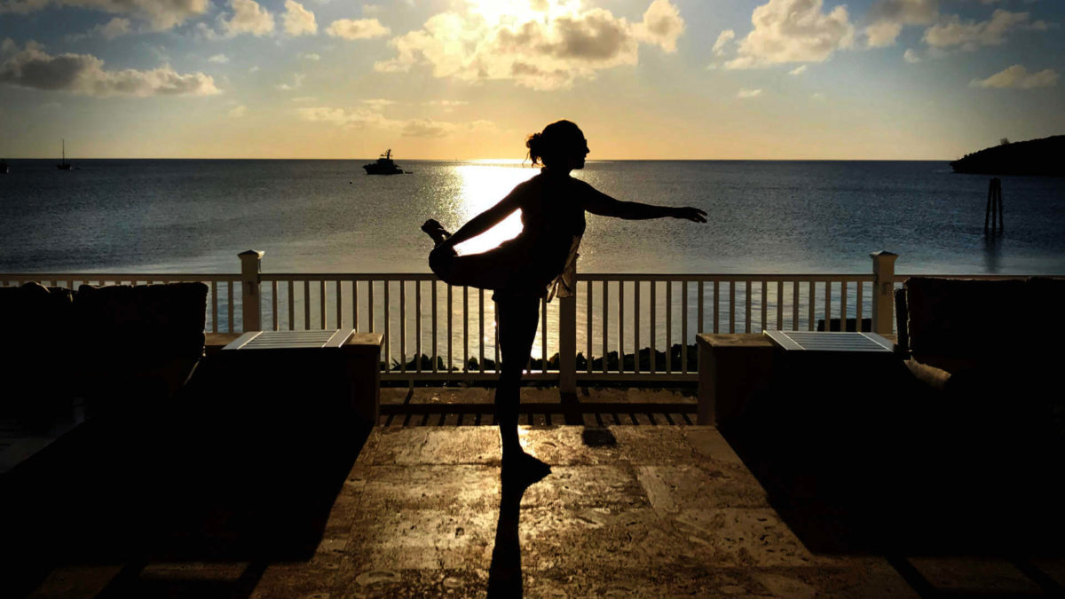 A healthy work-life balance with your email takes practice and effort. Jenni poses, balanced, on a patio in Eleuthera, Bahamas.