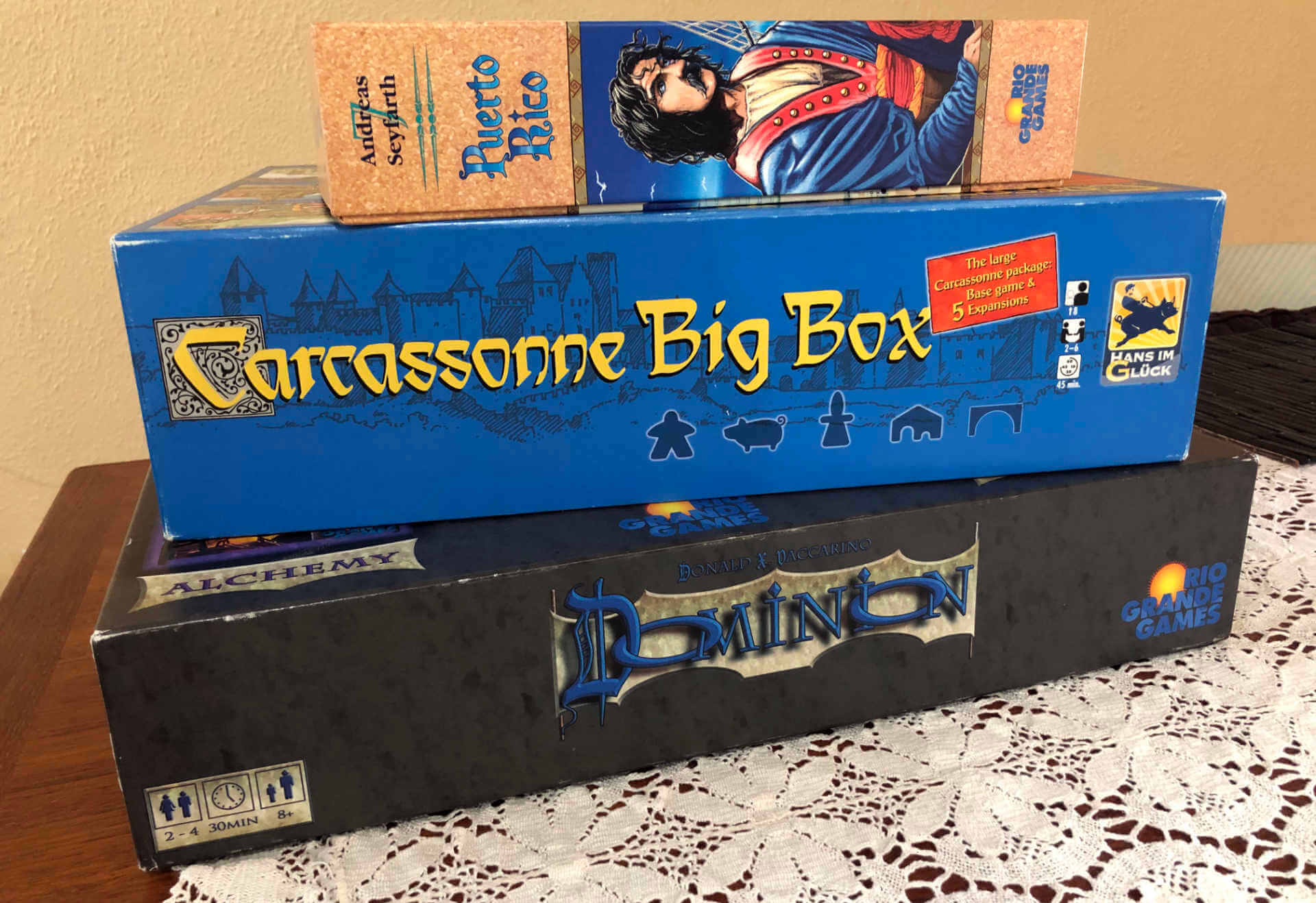 Three of the board games that are more approachable, European style strategy (instead of luck) focussed games: Dominion, Carcassonne, and Puerto Rico.