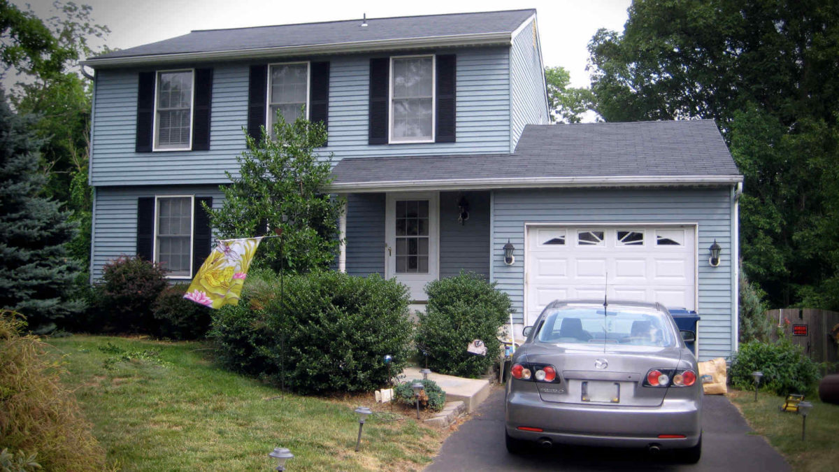 Should you pay off your mortgage or invest when you have extra money available? Pictured: the childhood home I remember best.