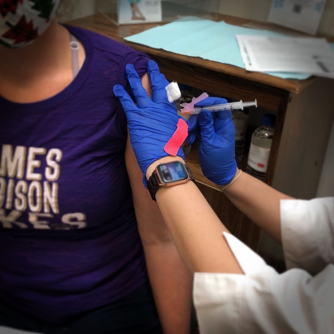 Jenni receiving her first Moderna vaccine injection on New Year's Eve.