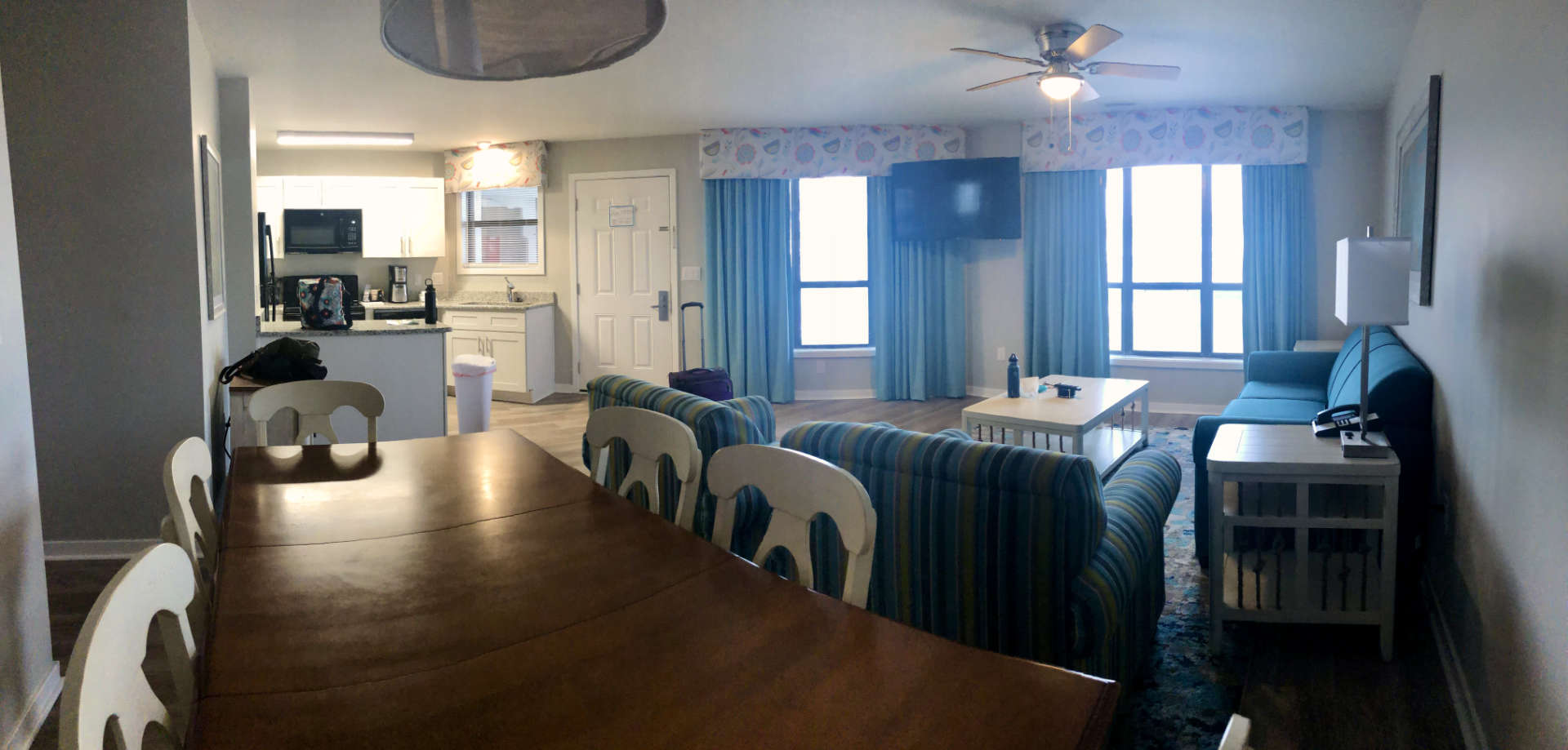 The dining room, living room, and kitchen setup in our beach condo.