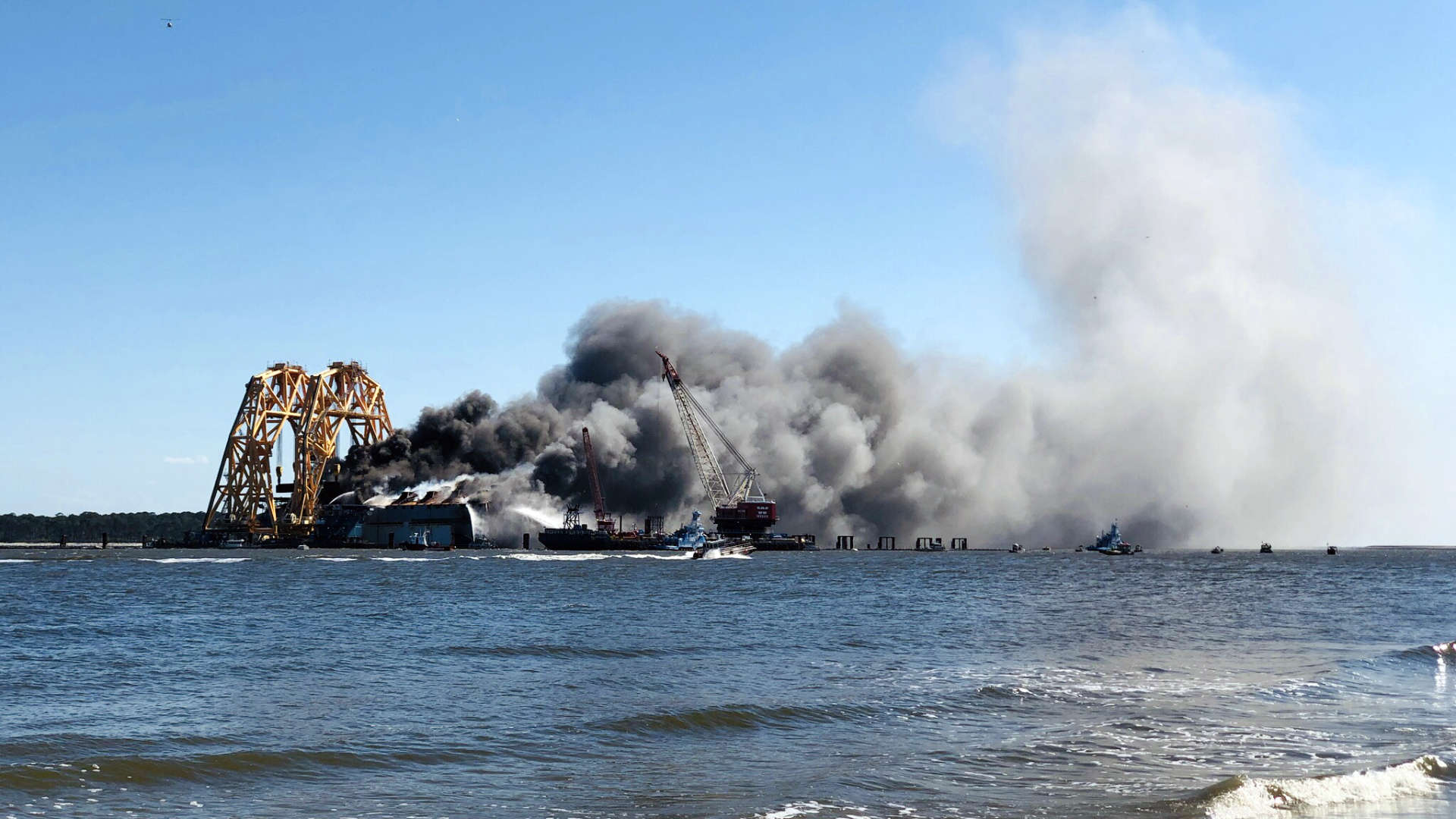 An overturned cargo ship, slowly being disassembled and removed the past two years, caught fire just off Saint Simons Island while we were visiting!