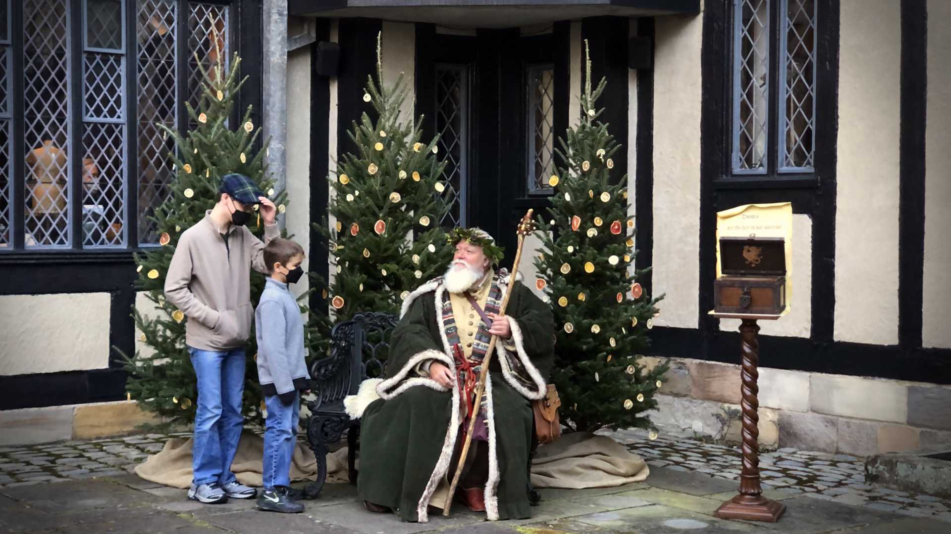 Father Christmas hearing children's wishes at a 15th Century Tudor Manor Estate.