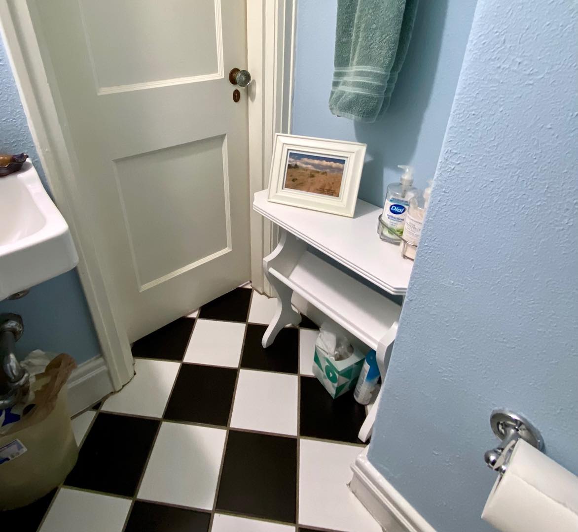 This little [now white] table just barely fits in our first floor powder room. The white paint matches well, though!